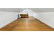 Spacious attic with hardwood floors, sloped ceilings, and a bright window at 2232 S Ogden St, Denver, CO 80210
