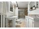 Basement bathroom with tiled floors, sliding glass shower, and vanity with a marble countertop at 2232 S Ogden St, Denver, CO 80210