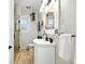 Bathroom featuring a corner sink, tiled floors, and a glass-door shower with mosaic tile accents at 2232 S Ogden St, Denver, CO 80210