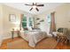Cozy bedroom featuring a ceiling fan, neutral decor, and natural light at 2232 S Ogden St, Denver, CO 80210