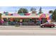 Colorful building exterior with ample seating and a red car parked nearby at 2232 S Ogden St, Denver, CO 80210