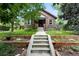 Delightful brick home with a lush lawn and landscaped garden beds at 2232 S Ogden St, Denver, CO 80210