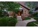 Charming brick home with a cozy front porch and well-maintained landscaping at 2232 S Ogden St, Denver, CO 80210