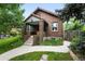 Charming brick home with a cozy porch and easy access to the driveway at 2232 S Ogden St, Denver, CO 80210