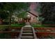 Lovely brick home with a red tile roof, landscaped yard and inviting entryway at 2232 S Ogden St, Denver, CO 80210