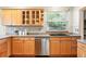 Kitchen featuring wood cabinets, granite countertops, and stainless steel appliances at 2232 S Ogden St, Denver, CO 80210