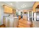 Kitchen with an island, stainless appliances, wood cabinets, and mosaic backsplash at 2232 S Ogden St, Denver, CO 80210