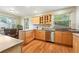 Kitchen showcasing wood cabinetry, granite countertops, and stainless steel dishwasher at 2232 S Ogden St, Denver, CO 80210
