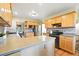 Bright kitchen featuring wood cabinets, granite countertops, mosaic backsplash, and stainless appliances at 2232 S Ogden St, Denver, CO 80210