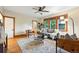 Well-lit living room featuring hardwood floors, a ceiling fan, and comfortable furniture at 2232 S Ogden St, Denver, CO 80210