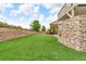 Backyard offers a well-manicured lawn, terraced landscaping, and ample space for activities at 3745 Spanish Oaks Trl, Castle Rock, CO 80108