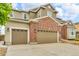 Two-story home with a two car garage, brick accents, and manicured lawn at 3745 Spanish Oaks Trl, Castle Rock, CO 80108
