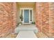 Charming entryway featuring a blue front door, brick accents, and decorative plants at 3745 Spanish Oaks Trl, Castle Rock, CO 80108