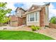 Charming two-story home with well-manicured lawn, brick accents, and a two-car garage at 3745 Spanish Oaks Trl, Castle Rock, CO 80108