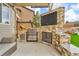 Outdoor kitchen featuring a built-in grill, counter space, and seating area, perfect for entertaining at 3745 Spanish Oaks Trl, Castle Rock, CO 80108