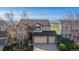 Aerial view of the two-story home situated on a large lot with mountain views at 9586 W Victoria Dr, Littleton, CO 80128