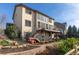 Home showcasing a spacious deck, a lower patio, and mature landscaping in the backyard at 9586 W Victoria Dr, Littleton, CO 80128