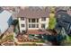 Aerial view of the home's rear exterior highlighting large windows, a spacious deck, and a backyard at 9586 W Victoria Dr, Littleton, CO 80128