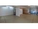 A spacious basement with epoxy floors and ample storage shelving provides room for hobbies or storage at 9586 W Victoria Dr, Littleton, CO 80128