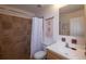 Bathroom featuring tiled shower, brushed nickel fixtures, and a functional vanity at 9586 W Victoria Dr, Littleton, CO 80128