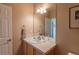 Bathroom featuring vanity and large mirror at 9586 W Victoria Dr, Littleton, CO 80128