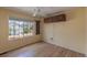 Empty bedroom featuring wood floors, a ceiling fan, and a bright window at 9586 W Victoria Dr, Littleton, CO 80128