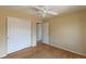 Empty bedroom featuring wood floors, a ceiling fan, and a double closet at 9586 W Victoria Dr, Littleton, CO 80128