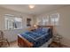 Bright bedroom featuring wood floors and natural light from multiple windows at 9586 W Victoria Dr, Littleton, CO 80128