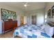 Bright bedroom featuring wood floors, a ceiling fan, and an interesting art piece above the dresser at 9586 W Victoria Dr, Littleton, CO 80128