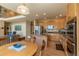 Updated kitchen with stainless steel appliances, island, and light wood cabinets at 9586 W Victoria Dr, Littleton, CO 80128