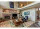 Cozy living room with a fireplace, hardwood floors, and comfortable chair at 9586 W Victoria Dr, Littleton, CO 80128