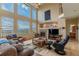 Bright living room showcasing a fireplace, large windows, and comfortable seating at 9586 W Victoria Dr, Littleton, CO 80128