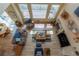 Aerial view of the living room with fireplace, high ceilings, and large windows at 9586 W Victoria Dr, Littleton, CO 80128
