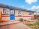 Brick home exterior boasts a cozy, fenced back patio, a blue security door, and outdoor utility access at 4201 Shoshone St, Denver, CO 80211