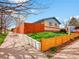 A street-level exterior view showcases a fenced-in yard with a mix of wood and concrete accents at 4201 Shoshone St, Denver, CO 80211