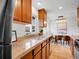Well-lit kitchen with stainless steel appliances, tile floor and granite countertops at 4201 Shoshone St, Denver, CO 80211