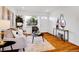 Bright living room with hardwood floors, a comfortable sofa, decorative mirrors, and a view to the outside at 4201 Shoshone St, Denver, CO 80211