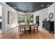 Elegant dining room with a chandelier, round table, and floor to ceiling windows offering beautiful views at 6123 Buffalo Run, Littleton, CO 80125