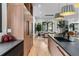Sleek kitchen with black countertops, wood cabinets, stainless steel appliances, and adjacent dining area at 6123 Buffalo Run, Littleton, CO 80125