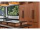 Kitchen island with a black countertop, wood cabinets, and stainless steel appliances at 6123 Buffalo Run, Littleton, CO 80125