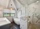 Modern bathroom featuring a soaking tub, glass shower, a vessel sink, and mountain views at 24172 Jerome Ct, Golden, CO 80401