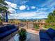 Inviting deck with wicker furniture offers breathtaking views of the mountains and picturesque scenery at 24172 Jerome Ct, Golden, CO 80401