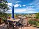 Outdoor deck with dining seating and mountain view at 24172 Jerome Ct, Golden, CO 80401