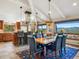 Bright dining room features an ornate light fixture and seating for six with mountain views at 24172 Jerome Ct, Golden, CO 80401