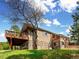 Exterior view of home with stone accents, multiple decks, and mature trees at 24172 Jerome Ct, Golden, CO 80401