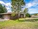 Well-maintained home exterior with mature trees, lush green lawn, and an attached garage at 24172 Jerome Ct, Golden, CO 80401