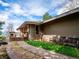 Side view of house with stone pathway and inviting deck create curb appeal at 24172 Jerome Ct, Golden, CO 80401