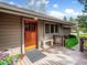 Charming entrance with a wood door, adjacent bench, and lush landscaping create a welcoming entryway at 24172 Jerome Ct, Golden, CO 80401