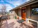 Inviting entrance with wood door, adjacent bench, and potted plants add to the exterior's appeal at 24172 Jerome Ct, Golden, CO 80401