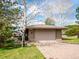 Attached two-car garage with paved driveway and landscaped front yard at 24172 Jerome Ct, Golden, CO 80401